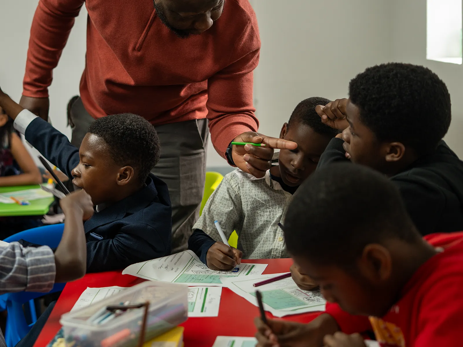 Children doing activities at a table with a leader at City of David Cambridge.