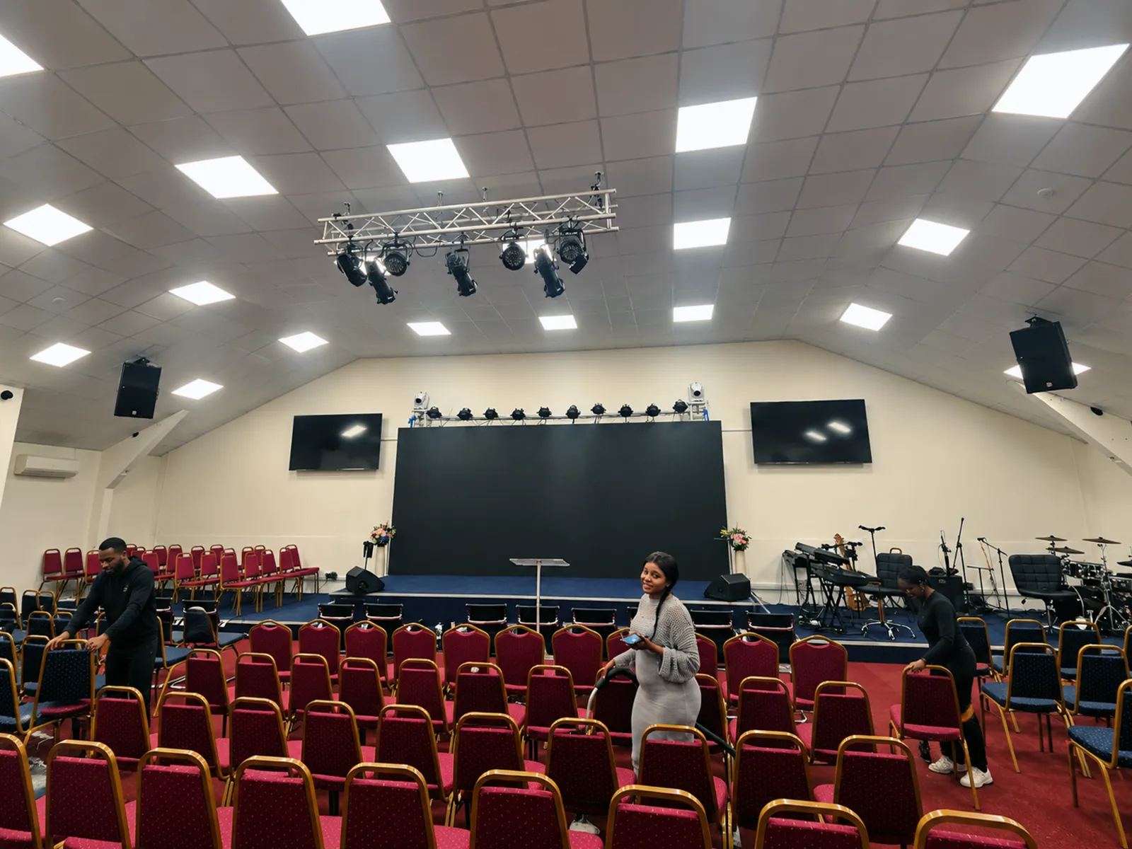 Church auditorium with stage, lighting and seating arranged for a service.